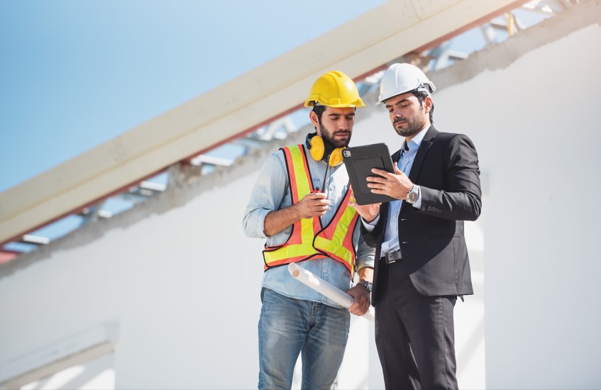 Professionnel faisant passer un test de sécurité à un intérimaire dans un chantier